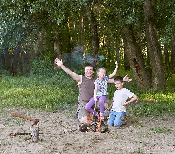 istock people camping in forest, family active in nature, kindle fire 603865332