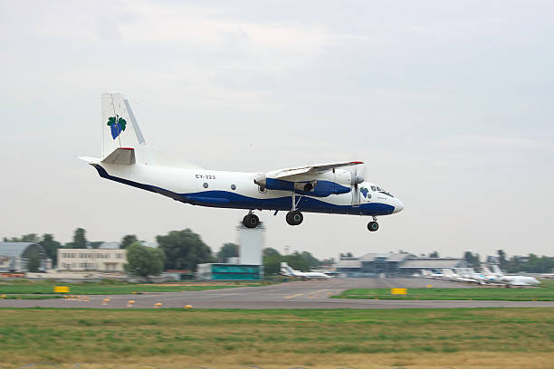 Antonov An-26 cargo plane Kiev, Ukraine - July 31, 2012: Antonov An-26 cargo plane is landing in the airport on a cloudy day antonov an 26 stock pictures, royalty-free photos & images