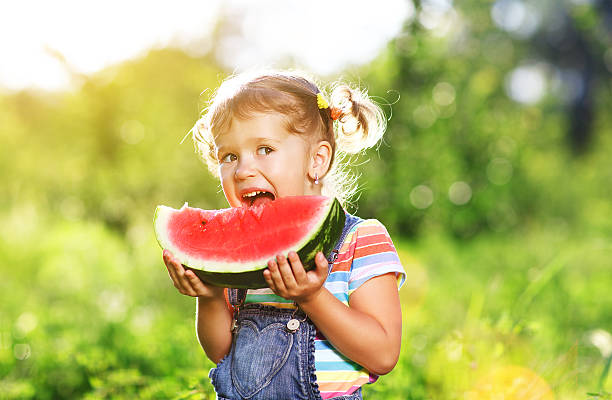 istock Happy child girl eats watermelon 603868846