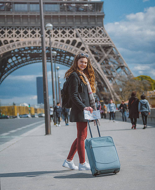 istock Young tourist woman walking with suitcase 603868980