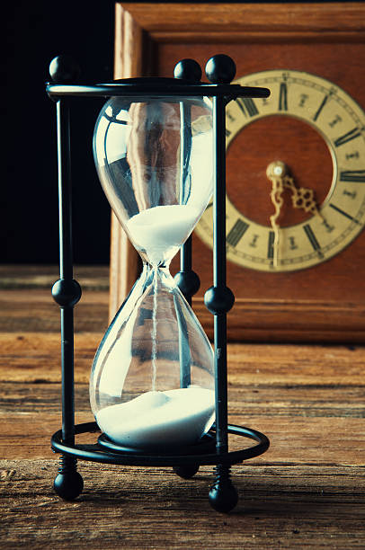 istock Hourglass and old vintage clock 603869798