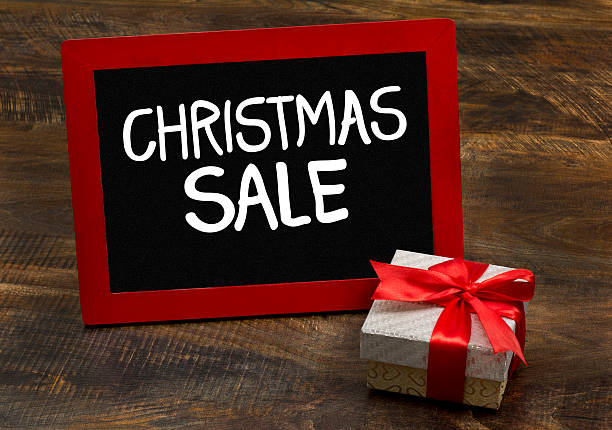 istock Christmas sale wooden frame chalkboard with gift pack 603870380