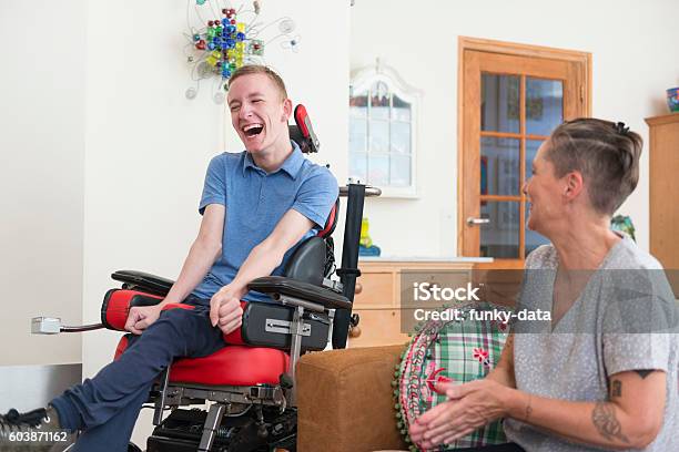 Happy Young Als Patient With His Mom Stock Photo - Download Image Now - Disability, Adult, Amyotrophic Lateral Sclerosis