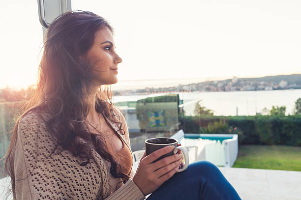 istock Woman drinking coffee at sunrise. 603872250