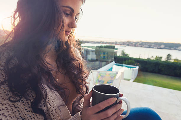 istock Woman drinking coffee at sunrise. 603872320