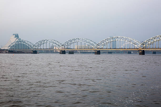 istock Iron railway bridge over river Daugava, Riga, Latvia 603874230