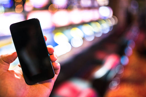 istock smartphone against a bokeh lights on a casino 603882346