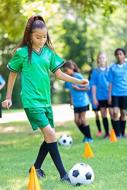 istock Young Hispanic girl practices soccer drills 603883886