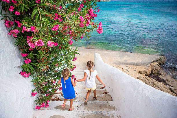 istock Two girls in blue dresses having fun outdoors. Kids at 603886868