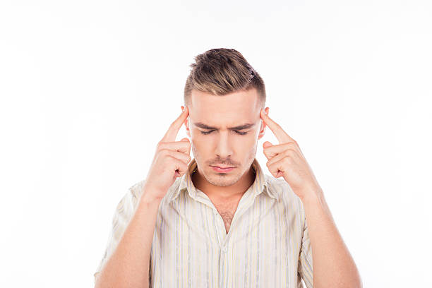 istock Handsome young man touching his head feeling strong headache 603887744
