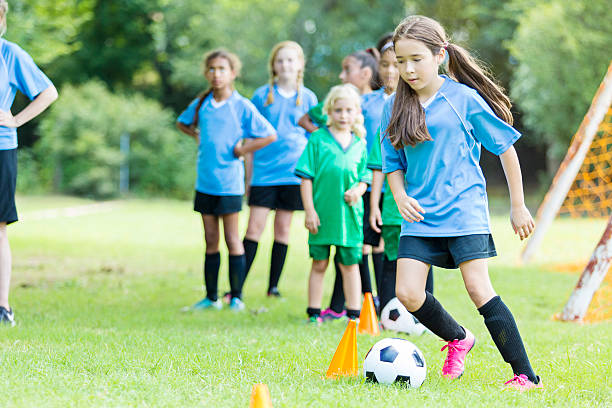 istock Focused preteen soccer player runs through practice drills 603888566