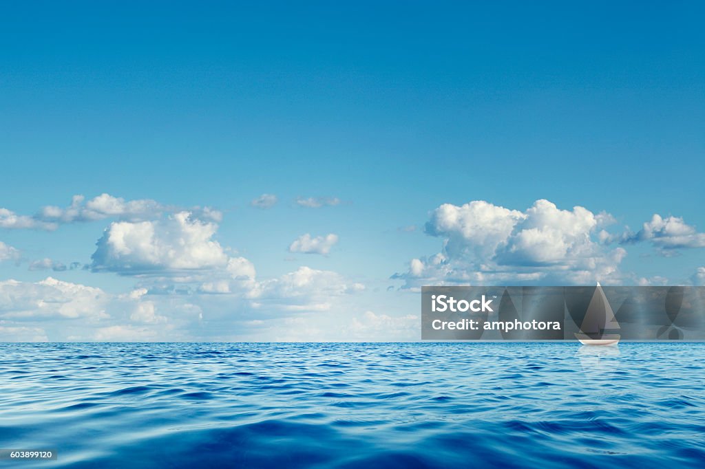 Lonely Sailboat Blue sea with white sailboat on the horizon. Sea Stock Photo