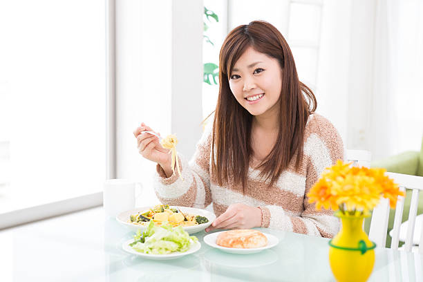 istock young attractive asian woman who  eats 603900994