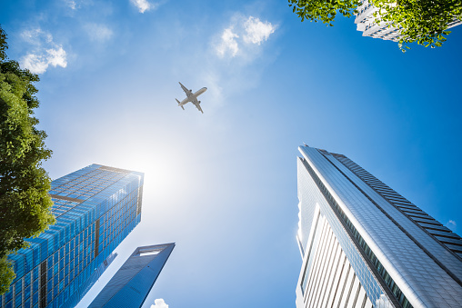 Airplane Flying Over Skyscrapers in Shanghai,China.