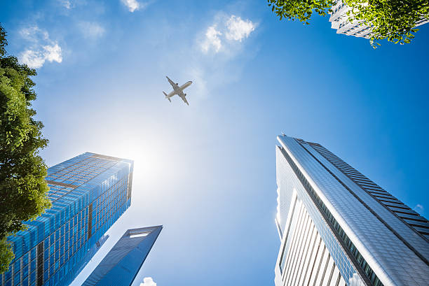 Airplane Flying Over Skyscrapers stock photo