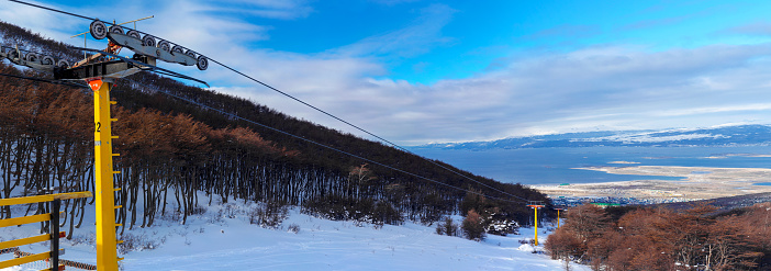 Panoramic view of Martial Glacier full of snow in the top at Ushuaia, Tierra del Fuego, Argentina. A beautiful place to practice winter sports such as skiing or snowboard in this place known as End of The World. Chairlifts for winter sports.