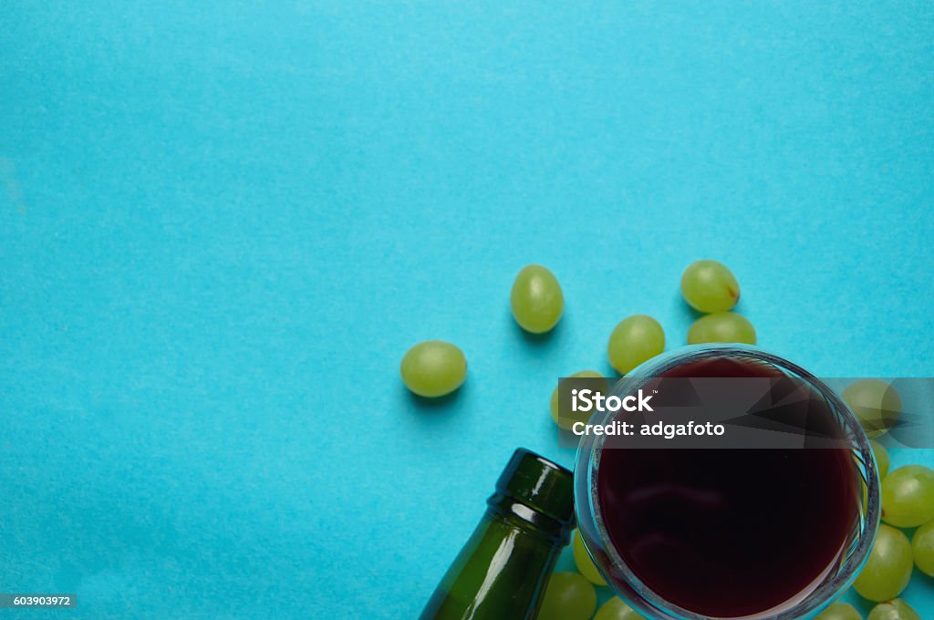 glass of wine and grapes, isolated on blue Agriculture Stock Photo