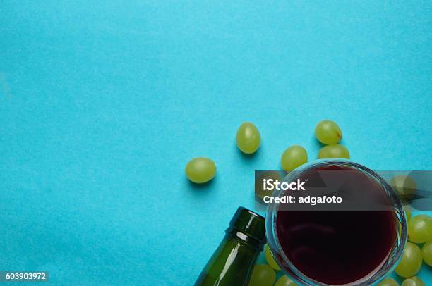 Glass Of Wine And Grapes Isolated On Blue Stock Photo - Download Image Now - Agriculture, Alcohol Abuse, Close-up