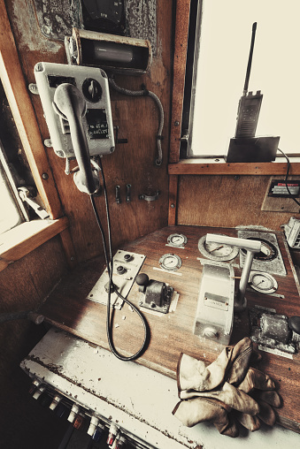 A neglected ship`s main throttle and engine room telephone.
