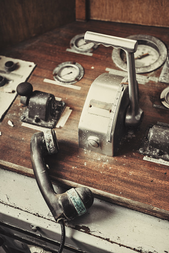 A neglected ship`s main throttle and engine room telephone.