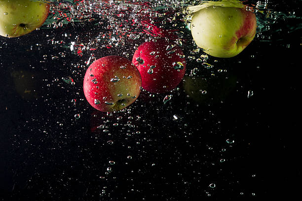 istock Apples in water on a black background 603904710