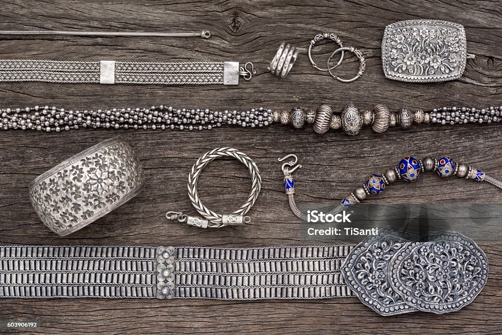 silver jewelry top view of antique traditional silver jewelry collection on old wood Antique Stock Photo