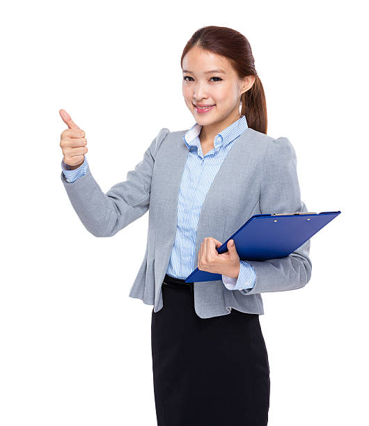 istock Businesswoman holding a clipboard 603907412