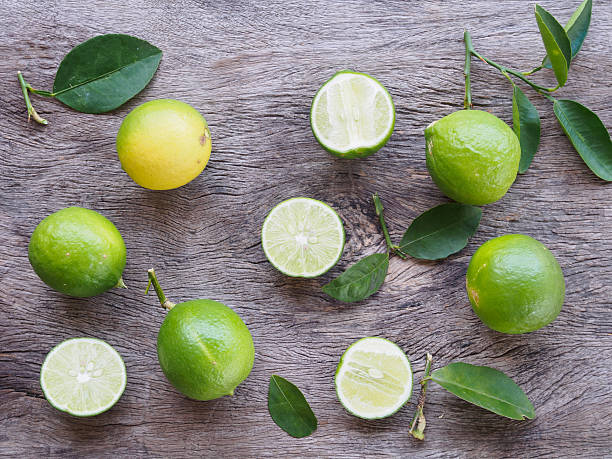 istock top view  fresh lime fruit  on wooden background 603907472