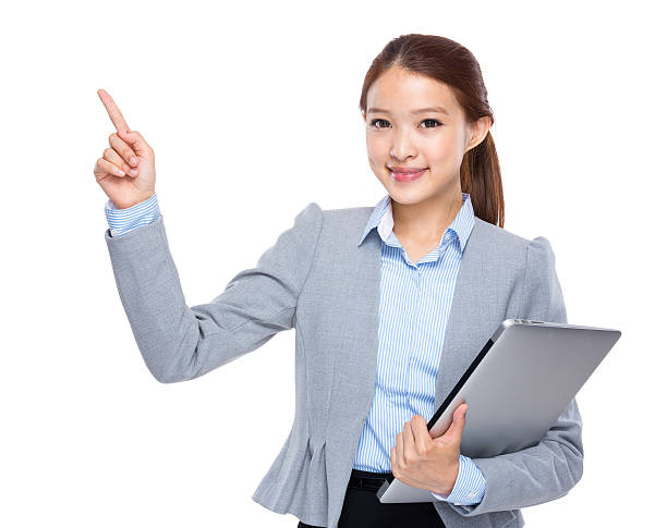 istock Woman holding a laptop and pointing 603907666