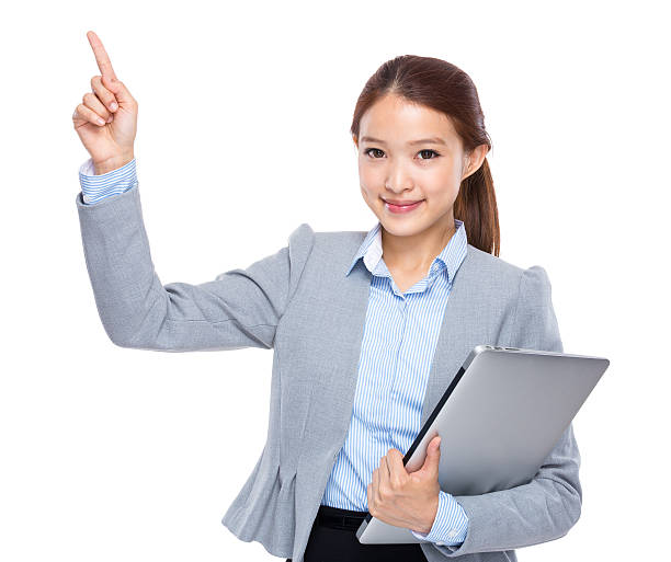 istock Woman holding a laptop and pointing 603907686