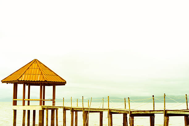 Walkway wooden into the pavilion on beach and sky background stock photo