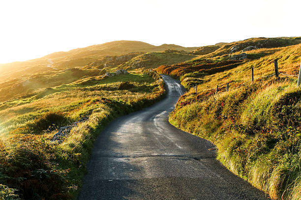 sky road, clifden, ireland - winding road sunlight field cultivated land imagens e fotografias de stock