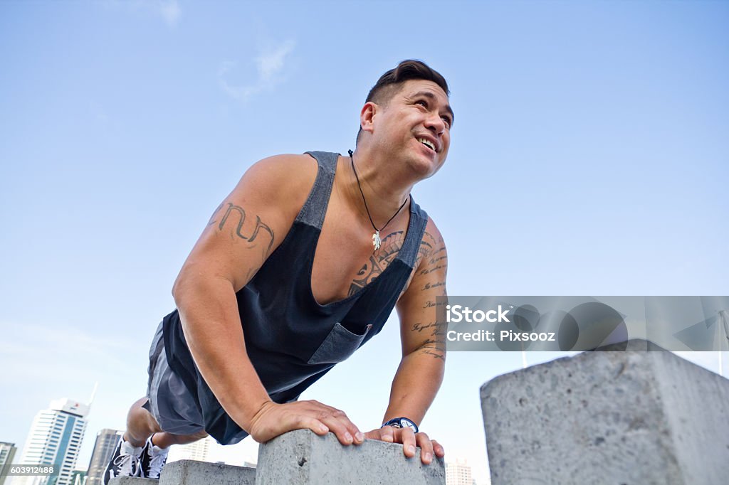 Fit man excercising in urban Auckland city buildings Pacific Islander Ethnic lifestyle fitness concept set on Auckland waterfront New Zealand New Zealand Stock Photo