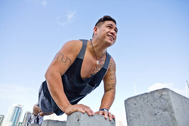 Fit man excercising in urban Auckland city buildings Pacific Islander stock photo