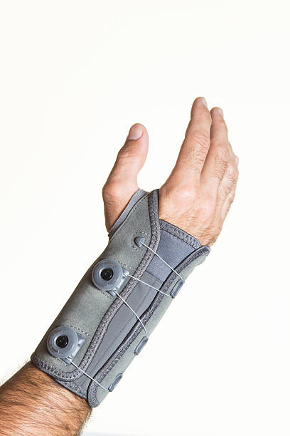 Bandage wrist with pressure regulator on man's hand - isolate Bandage wrist with pressure regulator on a man's hand - isolate on a white background pollex stock pictures, royalty-free photos & images
