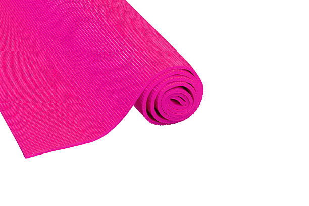 istock pink yoga mat isolated on white. 603990326