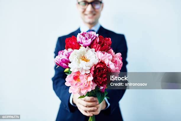 Take These Flowers Stock Photo - Download Image Now - Flower, Giving, Men