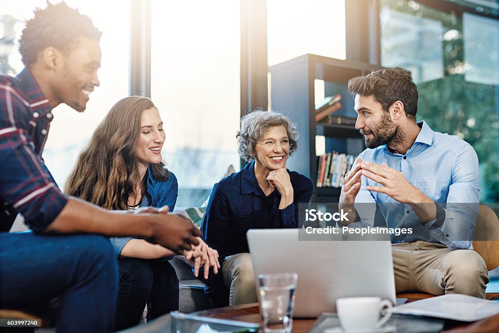 They’re always performing at their best Cropped shot of a group of creatives having a meeting in a modern office Happiness Stock Photo