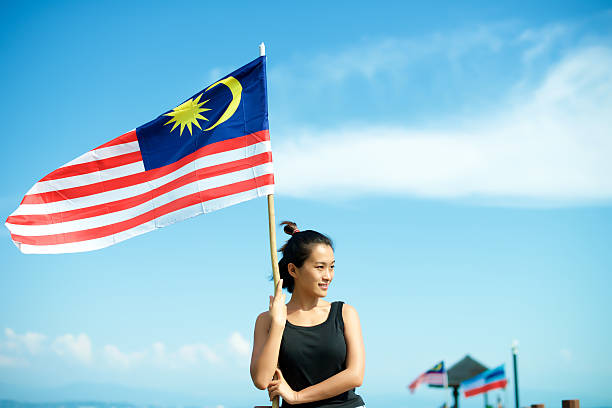 istock Girl on pier with Malaysian flag 603999244
