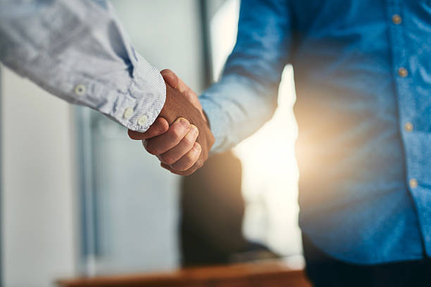 Let's shake on it Closeup shot of businesspeople shaking hands in an office casual clothing stock pictures, royalty-free photos & images