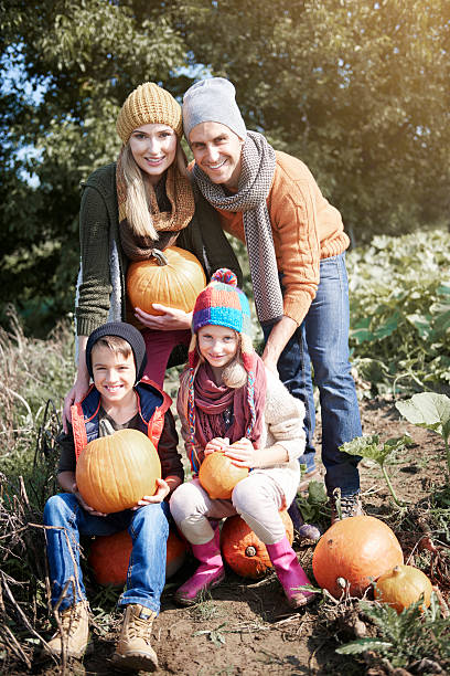 istock Whole family on pumpkin field 604004470