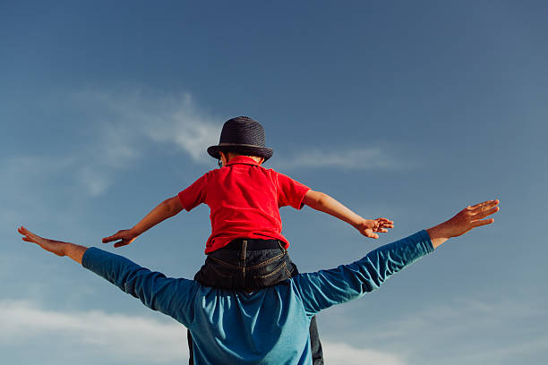 istock happy father and son playing on sky 604006410