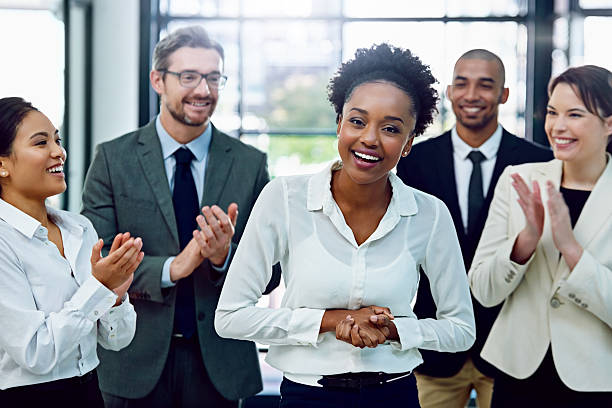 At last, her moment to shine Portrait of a succesful businesswoman being applauded by her colleagues in the office admiration photos stock pictures, royalty-free photos & images
