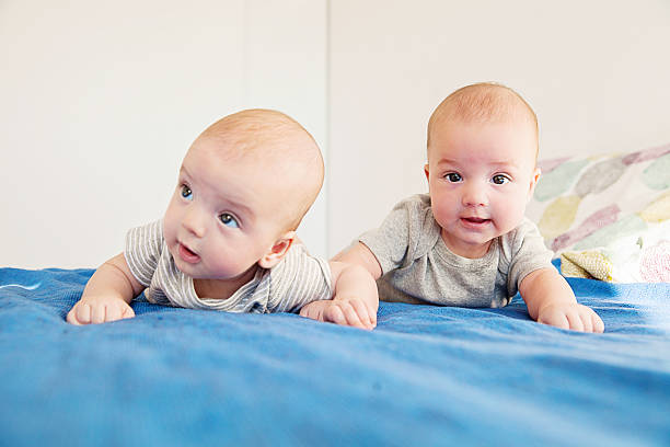istock Twin baby boys on lying down on bed 604007180
