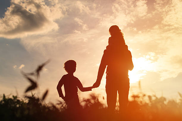 istock father with son and daughter walk at sunset 604007942