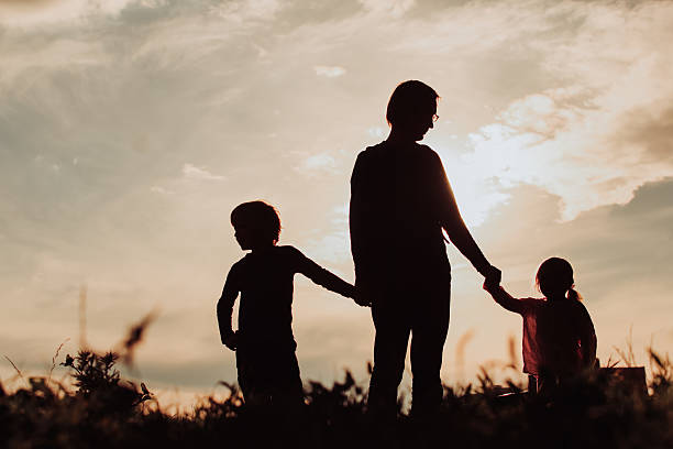 istock father with son and daughter walk at sunset 604008004