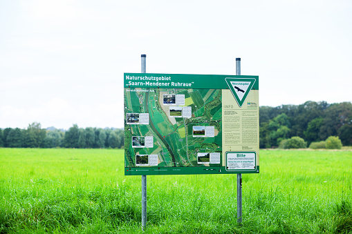 Mülheim, Germany - September 5, 2016: Information board about protected landscape at river Ruhr in outskirts of Mülheim Menden. On board is aerial pic of landscape and river. It is seated on northern riverside.