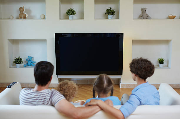 istock Watching tv as leisure for family 604010764