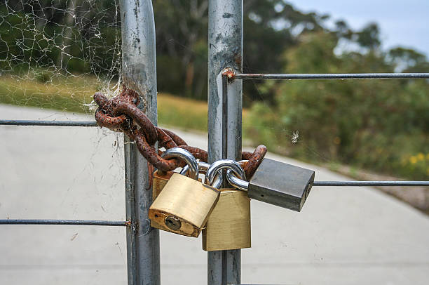 Padlocked metal gate in the country stock photo