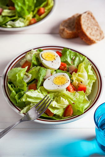 delicious fresh salad with boiled eggs and seeds